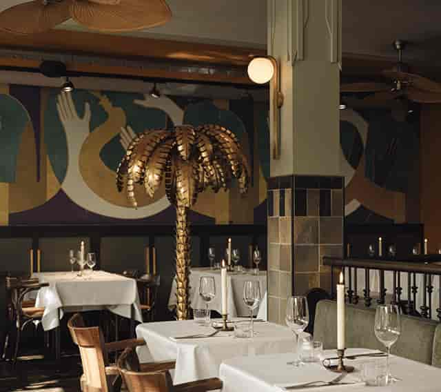 Stylish bar in Mata Hari with palm tree centerpiece for upscale corporate dinners and gatherings.