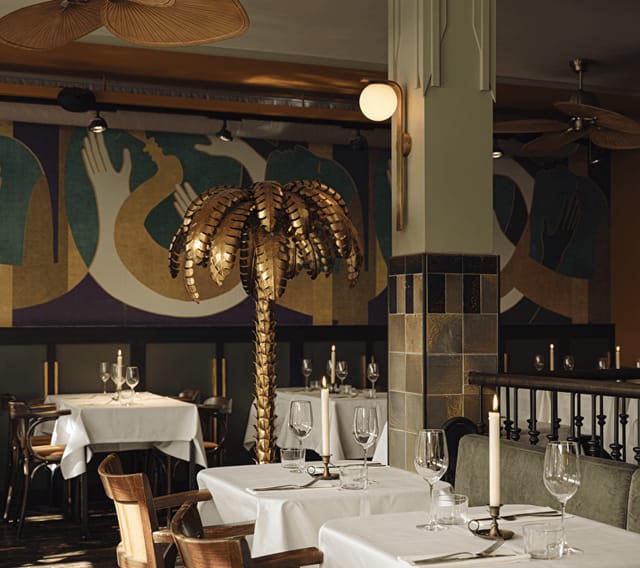 Stylish bar in Mata Hari with palm tree centerpiece for upscale corporate dinners and gatherings.