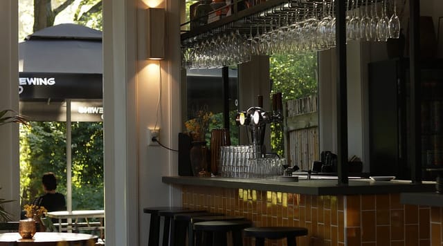 Stylish bar at The Old Bell with glassware, perfect for networking events and gatherings.