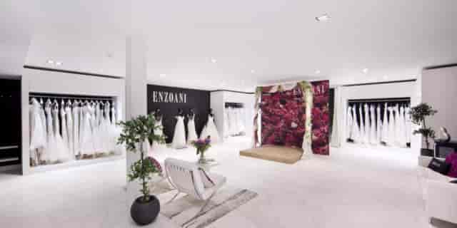 Elegant bridal boutique showcasing wedding gowns in a romantic setting for private fittings.