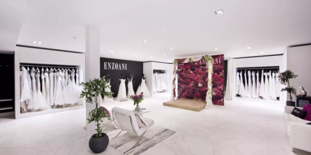 Elegant bridal boutique showcasing wedding gowns in a romantic setting for private fittings.