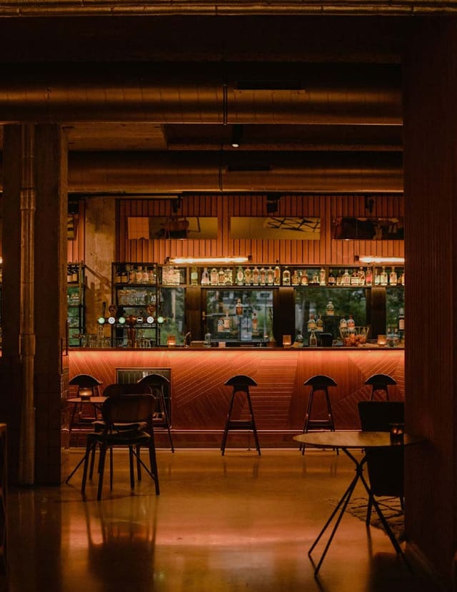 Modern wine bar with ambient lighting, perfect for networking and casual meetings.