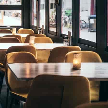 Peppino Lounge, Amsterdam: modern dining with yellow chairs for intimate gatherings.