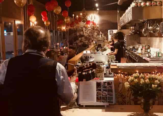 Intimate event space at D'Amici Vleuten with warm lighting and floral decor.
