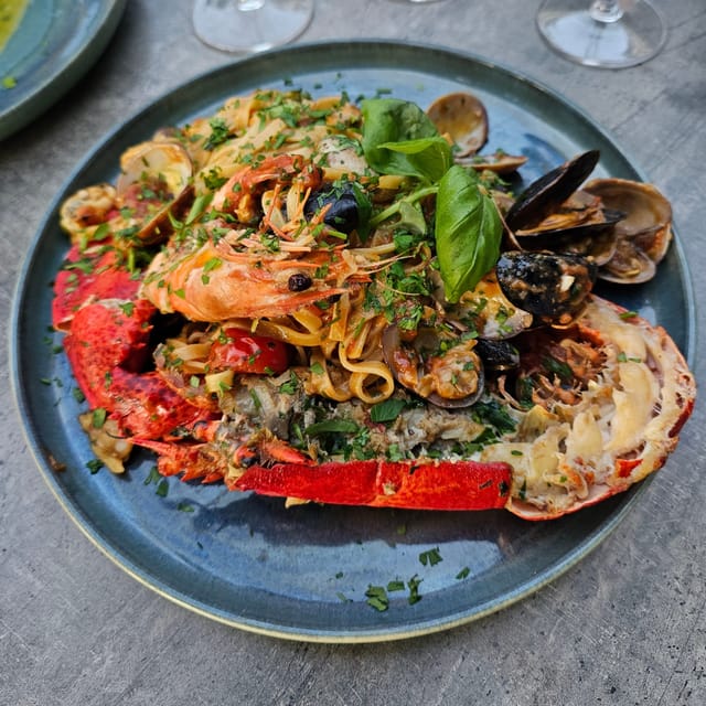 Vibrant lobster linguine dish at D'Amici Restaurant for events and catering.