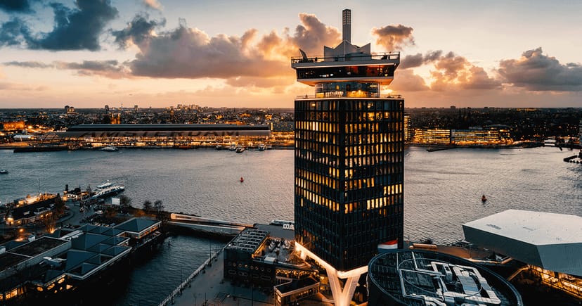 "Modern A'DAM Toren meeting room with panoramic views for upscale corporate events."