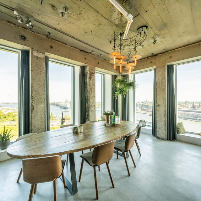 Modern A'DAM Toren meeting room with large windows, ideal for brainstorming sessions.