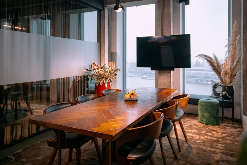 Modern meeting room with large wooden table for productive corporate meetings and events.