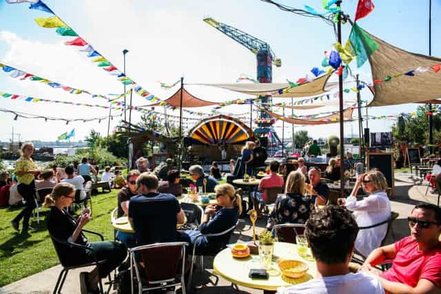 Vibrant outdoor event at Café Noorderlicht with colorful decorations and lively guests.