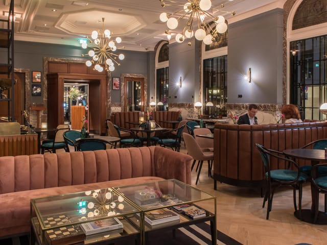 Chic lounge at Hotel Indigo The Hague, ideal for networking events and gatherings.