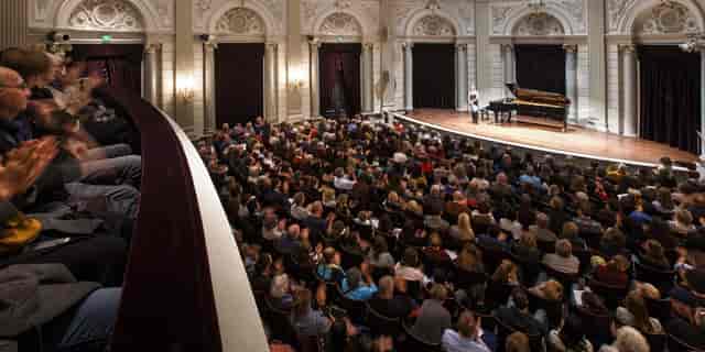 Packed Recital Hall at The Royal Concertgebouw, showcasing elegant architecture for events.