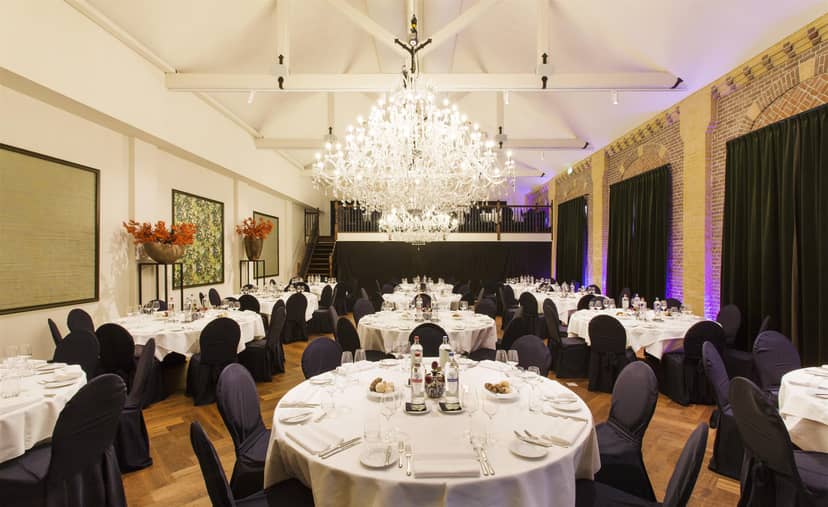 Grand Ballroom at The College Hotel Amsterdam with elegant decor for corporate events and dinners.