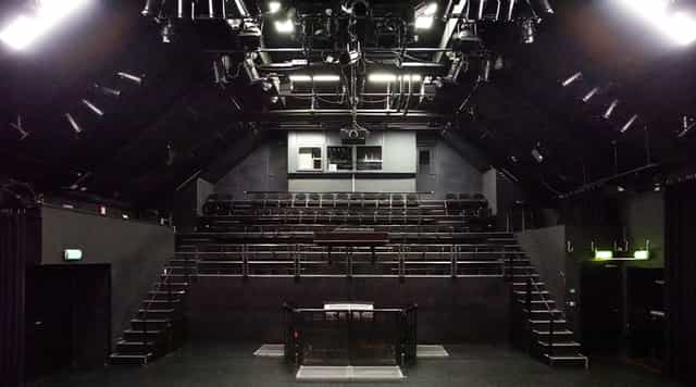 Versatile theater space at Melkweg, perfect for performances and lectures with elevated seating.