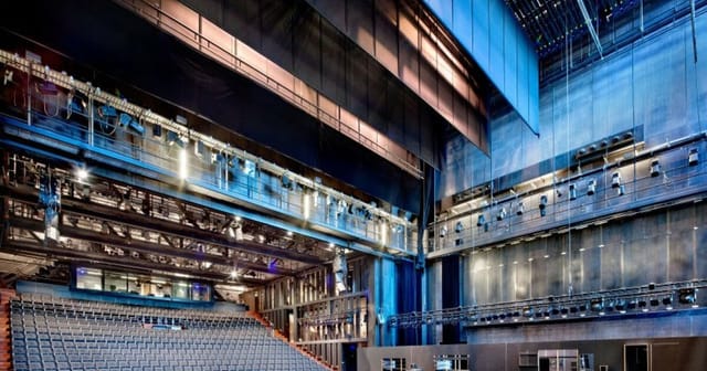 Modern event venue Rabozaal with large stage and tiered seating in Amsterdam.