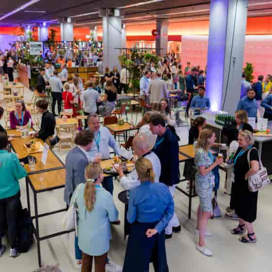 Vibrant networking event in Beatrix Theatre's Expo Room with informal seating and bar.