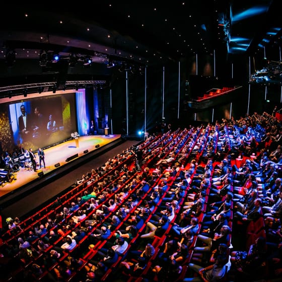 "Engaging speaker at Stage Entertainment Lounge for a professional conference event."