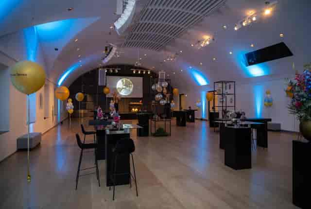 Elegant auditorium with blue lighting, perfect for corporate events and celebrations.