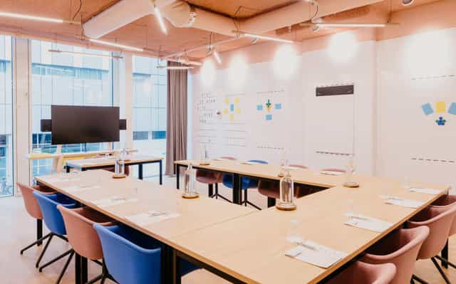 Modern coworking meeting room in Hotel Casa, featuring a long table and writable walls.