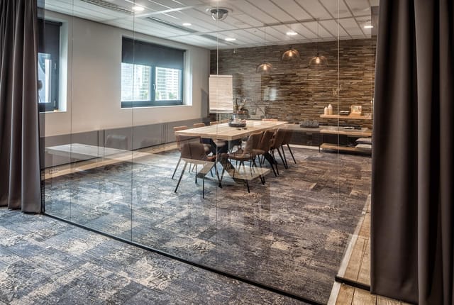 Modern meeting room with glass walls, perfect for presentations and collaboration.
