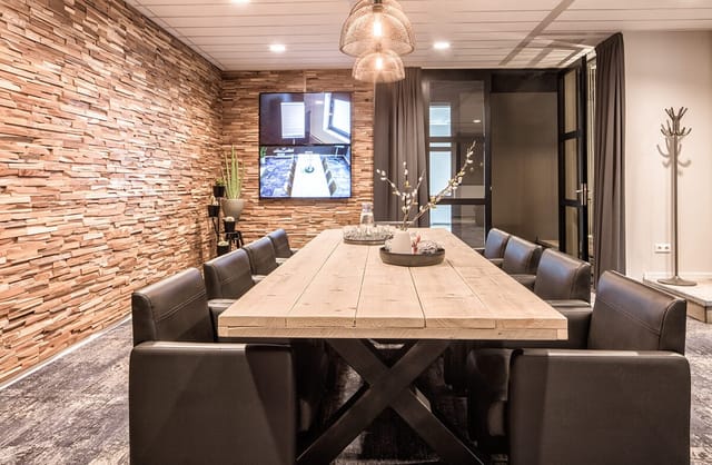 Modern conference room with wooden accents for hybrid meetings and collaboration.