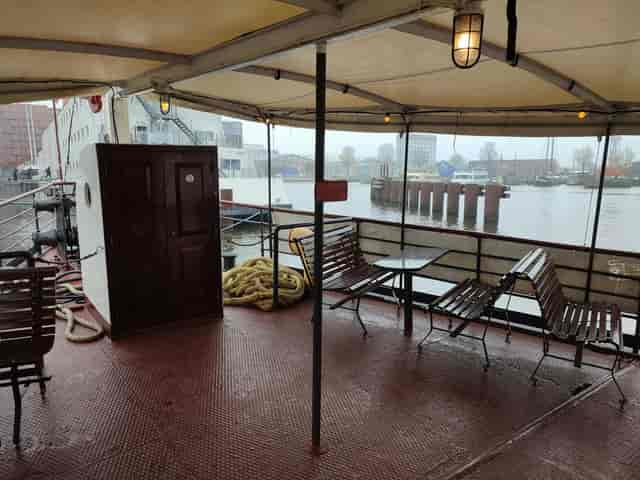 Outdoor meeting space on a boat with waterfront views for events and networking.
