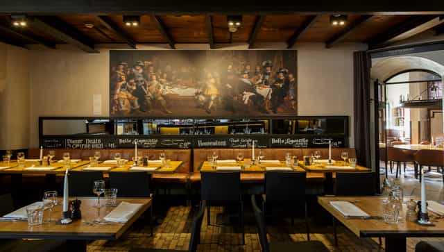 Elegant restaurant in Waag with long tables, perfect for events and gatherings.