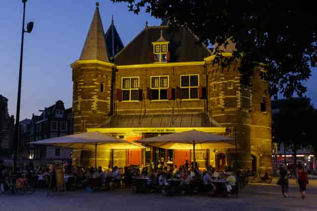 Charming Waag restaurant with outdoor seating, ideal for evening events and gatherings.