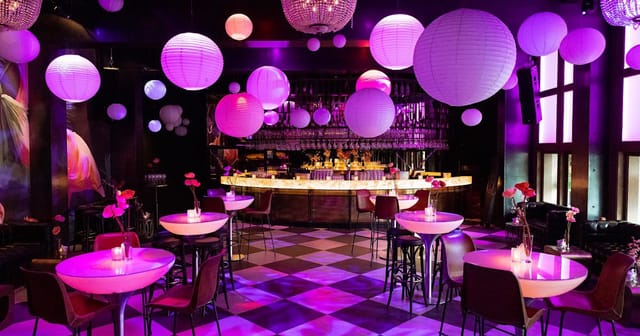 Stylish event space in De Kroon with purple lighting for upscale gatherings and networking.