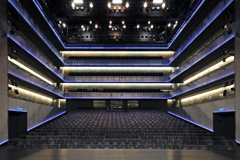 Modern auditorium with tiered seating, perfect for corporate events and performances.