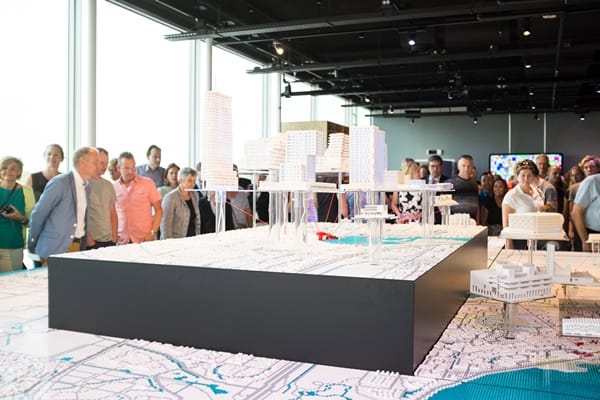 Dynamic event space with architectural model, ideal for real estate conference.