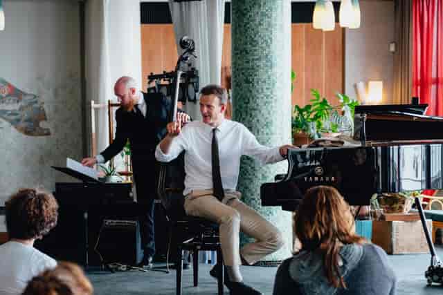 "Live pianist and bassist performance in modern KZ Lobby, perfect for corporate events."