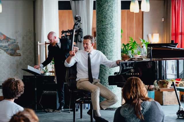 "Live pianist and bassist performance in modern KZ Lobby, perfect for corporate events."