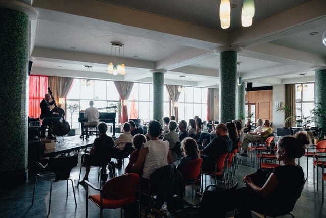 Centrale Hal event with seated audience, vibrant atmosphere for networking and entertainment.