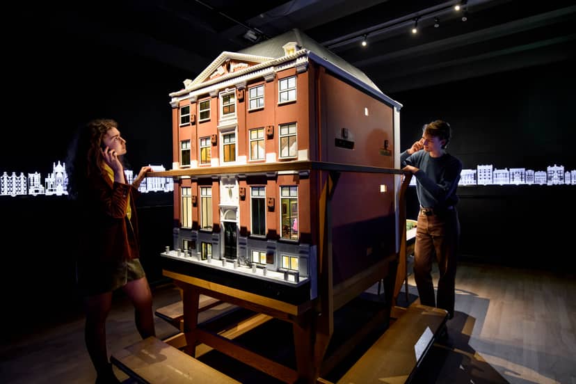 Professionals examining an architectural model at the Museum of the Canals for event planning.