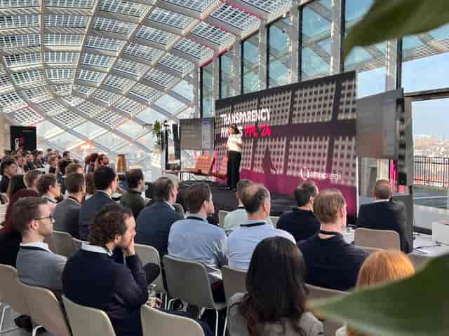 Engaged audience in modern Omnia Retail conference room during event presentation.