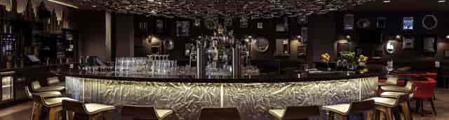 Sophisticated hotel bar with unique ceiling, ideal for networking events and receptions.