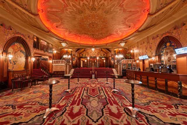 Ornate Tuschinski theater venue with grand ceiling, ideal for upscale events and galas.