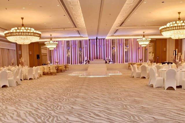 Elegant Arzanah Ballroom with round tables, ideal for weddings and corporate events.