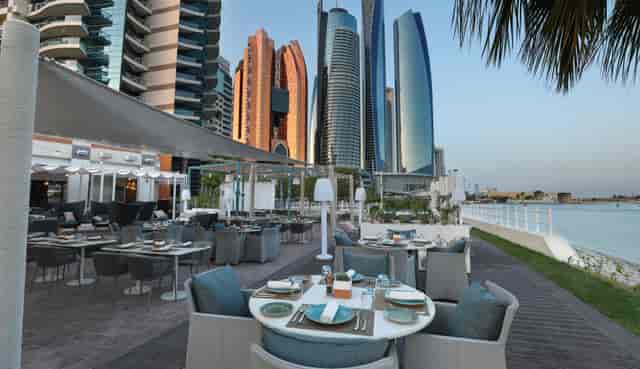 Kamoon Terrace outdoor dining with skyscraper views, perfect for corporate events.