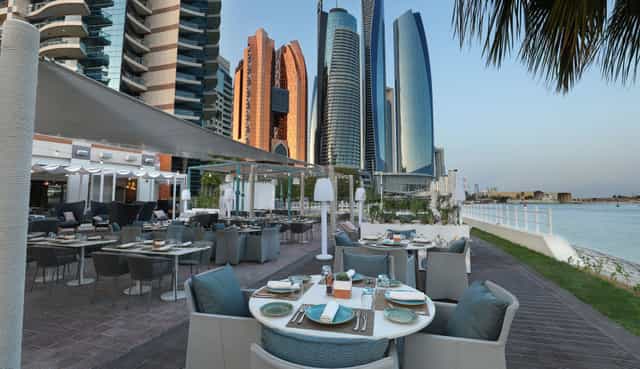 Kamoon Terrace outdoor dining with skyscraper views, perfect for corporate events.