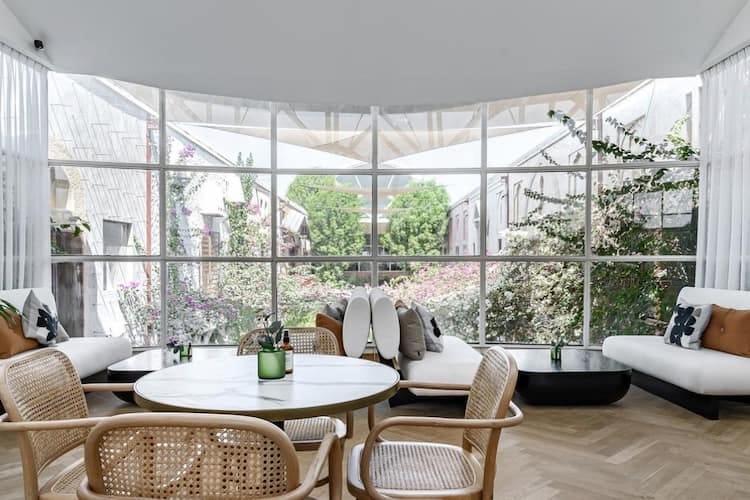 Stylish meeting space with natural light and greenery, ideal for brainstorming events.