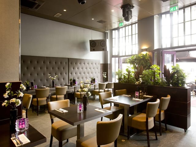 Contemporary restaurant with plush seating, ideal for intimate events in Royal Amsterdam.