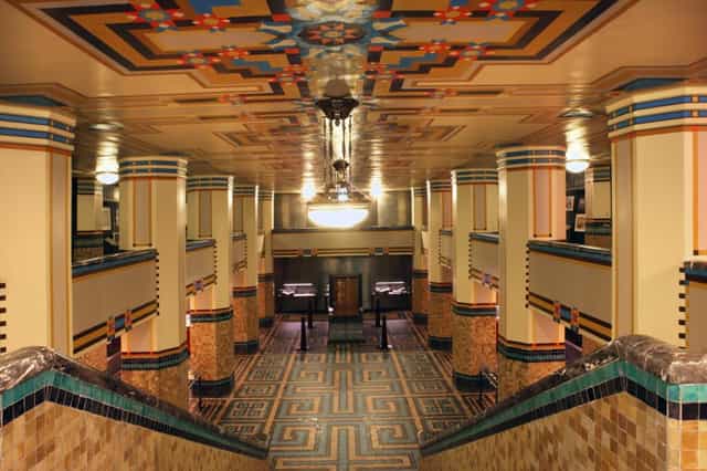 Art Deco event space in De Bazel Amsterdam with elegant lighting and vibrant patterns.