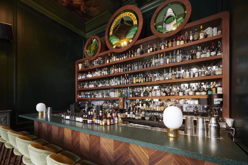 Stylish bar in The Flying Dutchman with green walls, perfect for cocktail receptions.