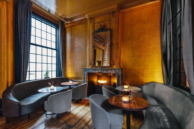Sophisticated meeting space in The Dylan Amsterdam with plush seating and warm lighting.
