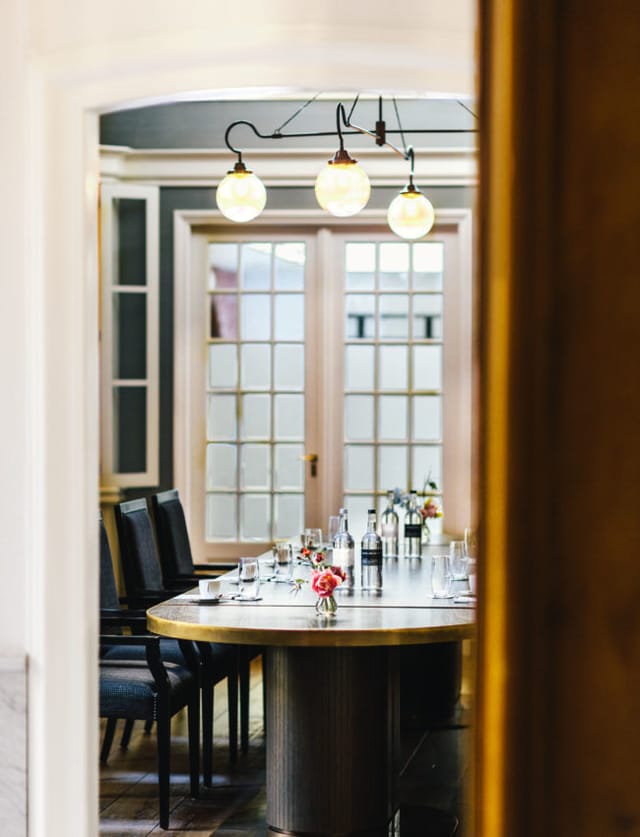 Meeting room in The Dylan Amsterdam with elegant table, ideal for corporate events.