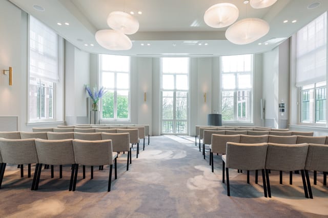 Maurits Room conference setup with natural light for events and networking.