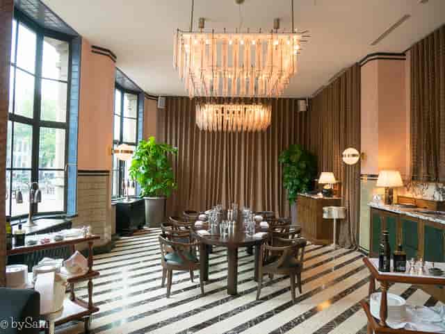 Private dining room at Soho House Amsterdam with elegant chandelier, ideal for upscale events.
