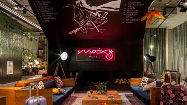Trendy Moxy Amsterdam lobby with vibrant decor for informal meetings and events