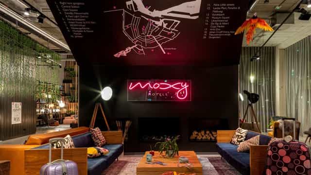 Trendy Moxy Amsterdam lobby with vibrant decor for informal meetings and events